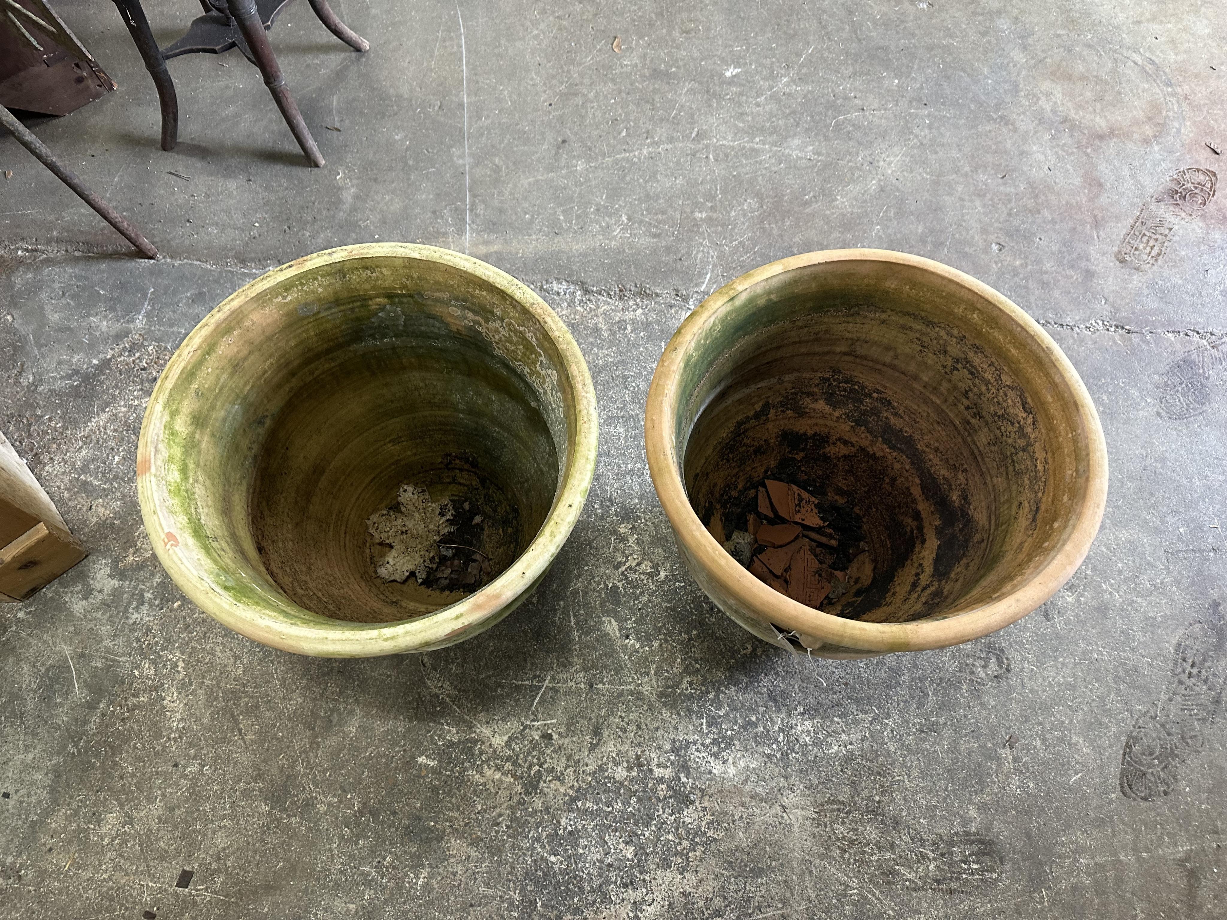 A pair of terracotta planters, diameter 46cm, height 45cm. Condition - fair to good